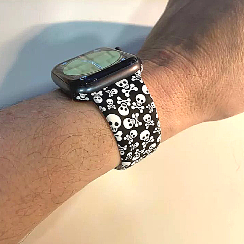 Closeup of Model's Wrist, Wearing Skull Style Designer Silicone Sport Band and Apple Watch.