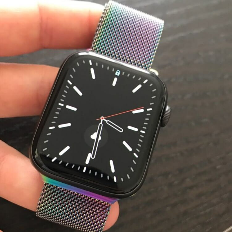 Closeup of Model's Hand, Holding a Multicolor Milanese Sport Loop Band and Apple Watch.