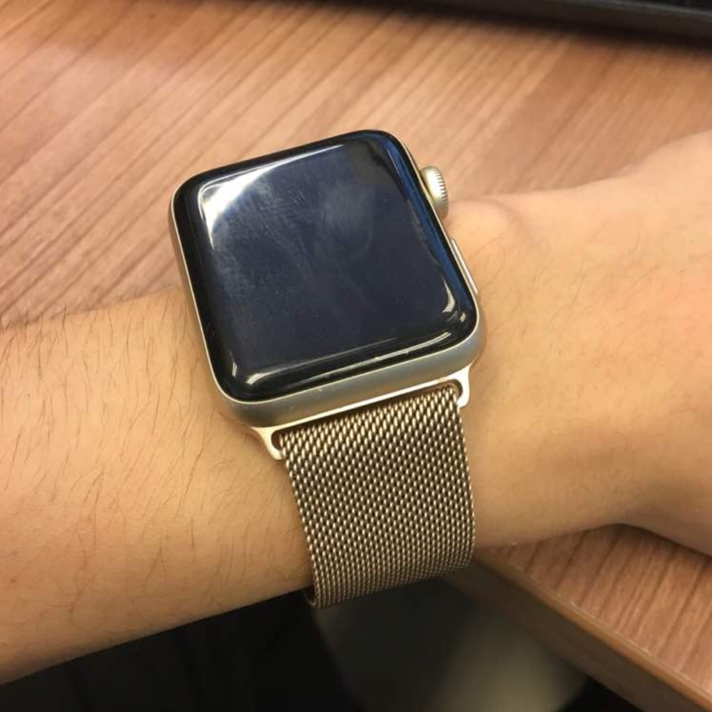 Closeup of Model's Wrist, Wearing a Gold Milanese Sport Loop Band and Apple Watch.