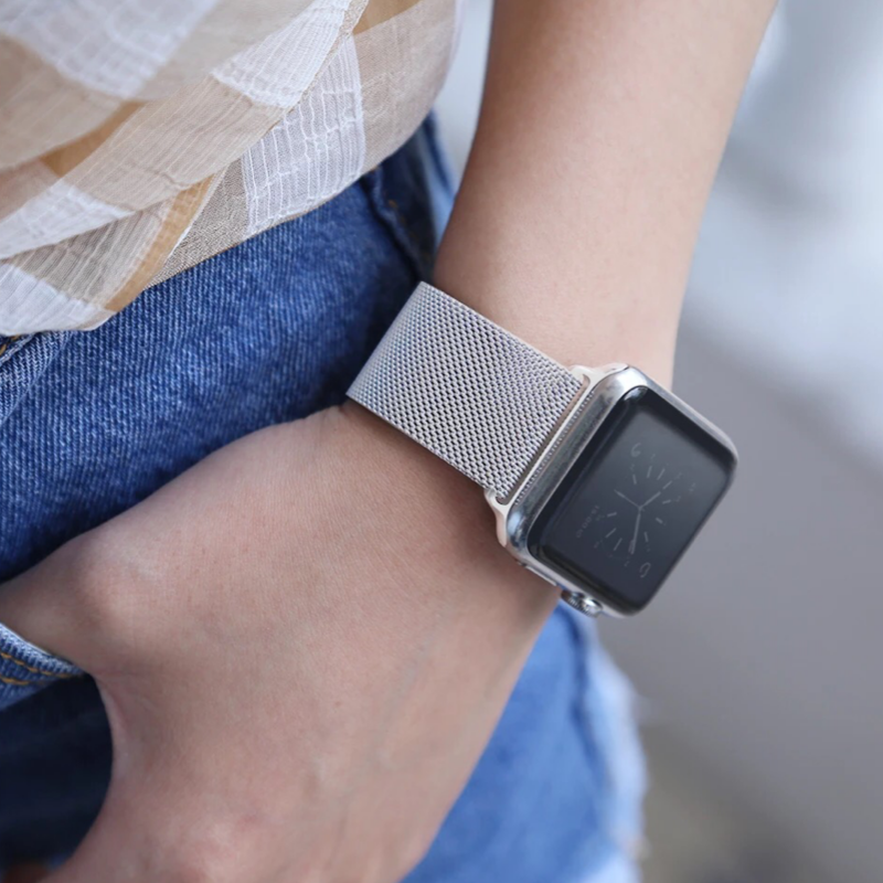 Closeup of Model's Wrist, Wearing a Silver Milanese Sport Loop Band and Apple Watch.