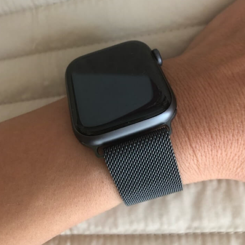 Closeup of Model's Wrist, Wearing a Space Gray Milanese Sport Loop Band and Apple Watch.