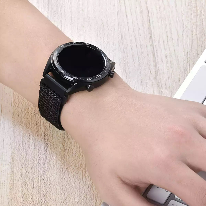 Closeup of Model’s Wrist, Wearing a Black Nylon Sport Universal Loop Band with Huawei Watch.