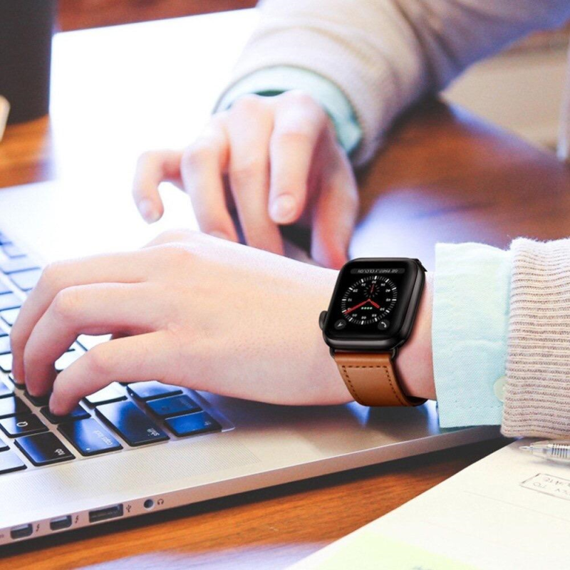 Another Closeup of Model's Wrist, Wearing a Saddle Brown Premium Leather Band with Apple Watch While Typing on a Keyboard.