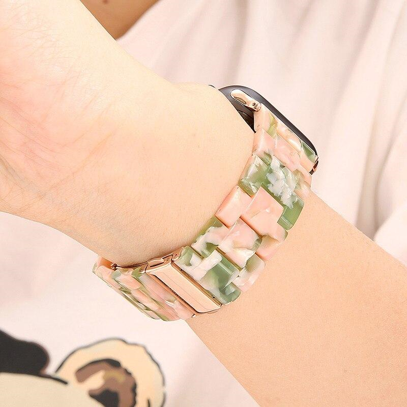 Closeup of Model's Wrist, Wearing a Pink and Sage Green Resin Band with Apple Watch.