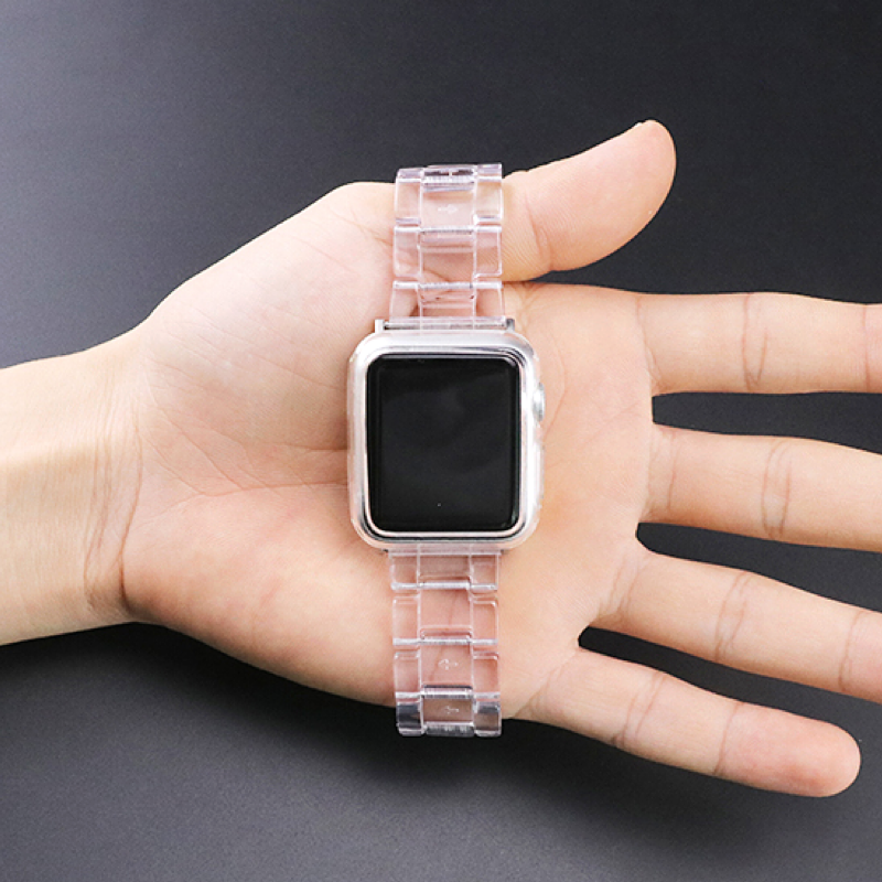 Closeup of Model's Hand, Holding a Clear Transparent Resin Band and Apple Watch.