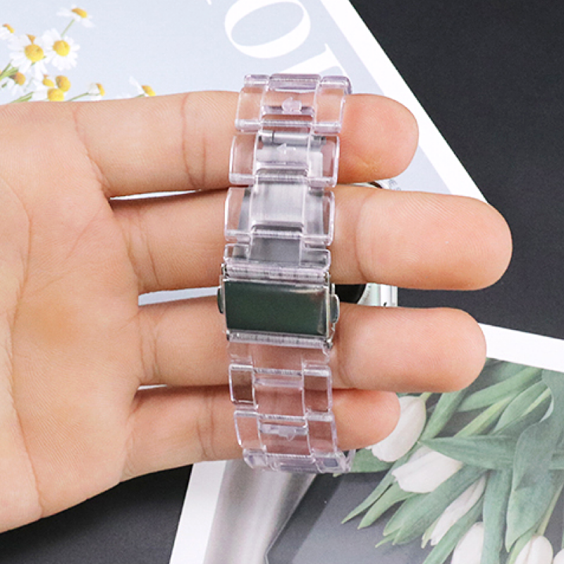 Closeup of Model's Hand, Holding a Clear Transparent Resin Band and Apple Watch - Reverse Side Shown.