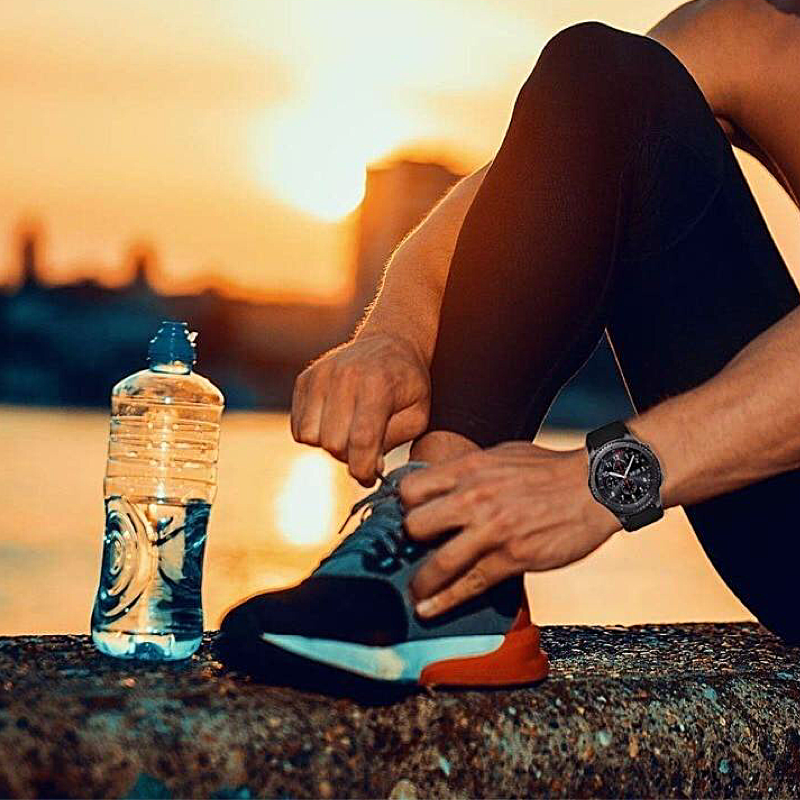 Male Runner Tying His Sneakers and Wearing a Samsung S3 Frontier with a Black Rugged Silicone Sport Universal Watch Band.