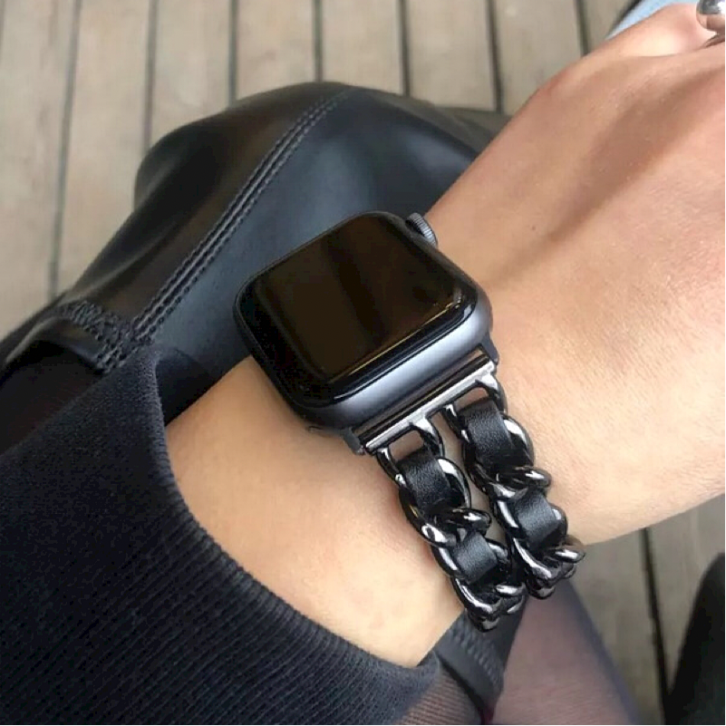 Closeup of Model's Wrist, Wearing a Black and Black Leather Chain Bracelet Band on a Space Gray Apple Watch.