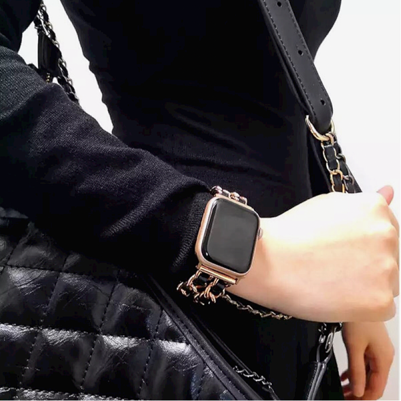 Another Closeup of Model's Wrist, Wearing a Rose Gold and Black Leather Chain Bracelet Band.