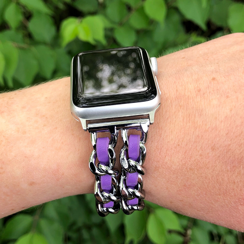 Closeup of Model's Wrist, Wearing a Silver and Violet Purple Leather Chain Bracelet Band on a Silver Apple Watch.