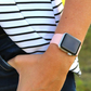 Closeup of Model’s Wrist, Wearing a Pink Silicone Sport Strap and Apple Watch.