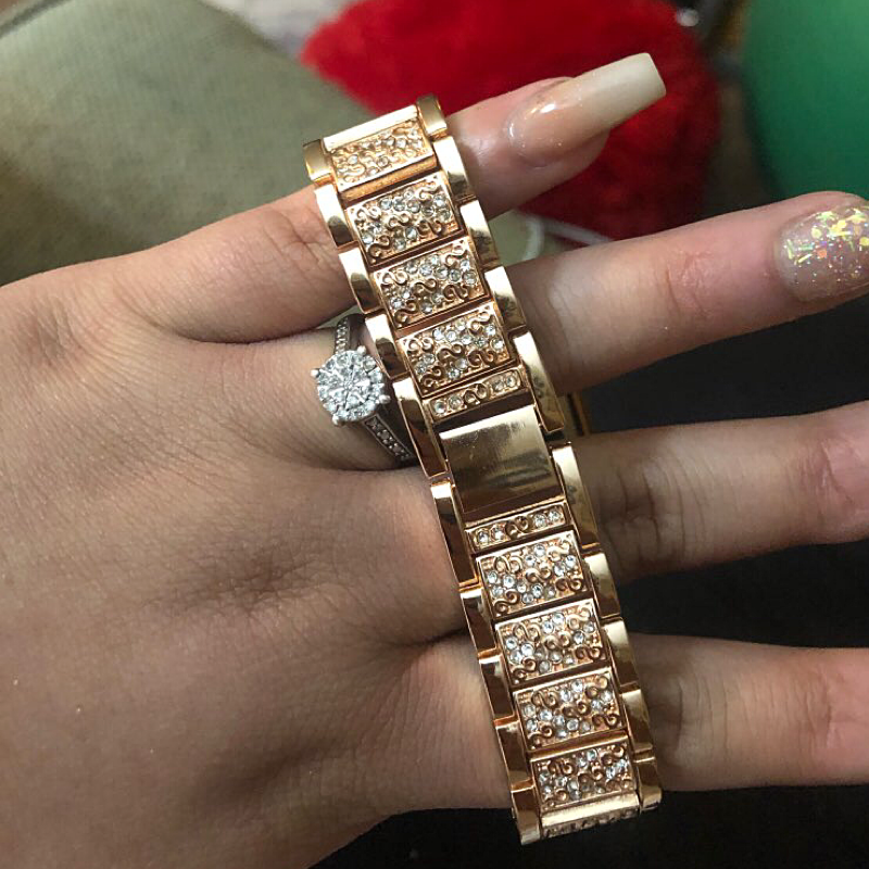 Closeup View of a Model's Hand, Holding an Apple Watch with a Gold Vintage Style Diamond Link Bracelet Band.